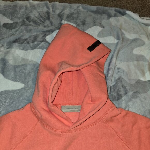 Fear of God Essentials Hoodie in Coral—a standout, soft-pink hue unisex oversize - Picture 5 of 5